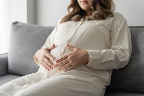 pregnant woman holding her stomach